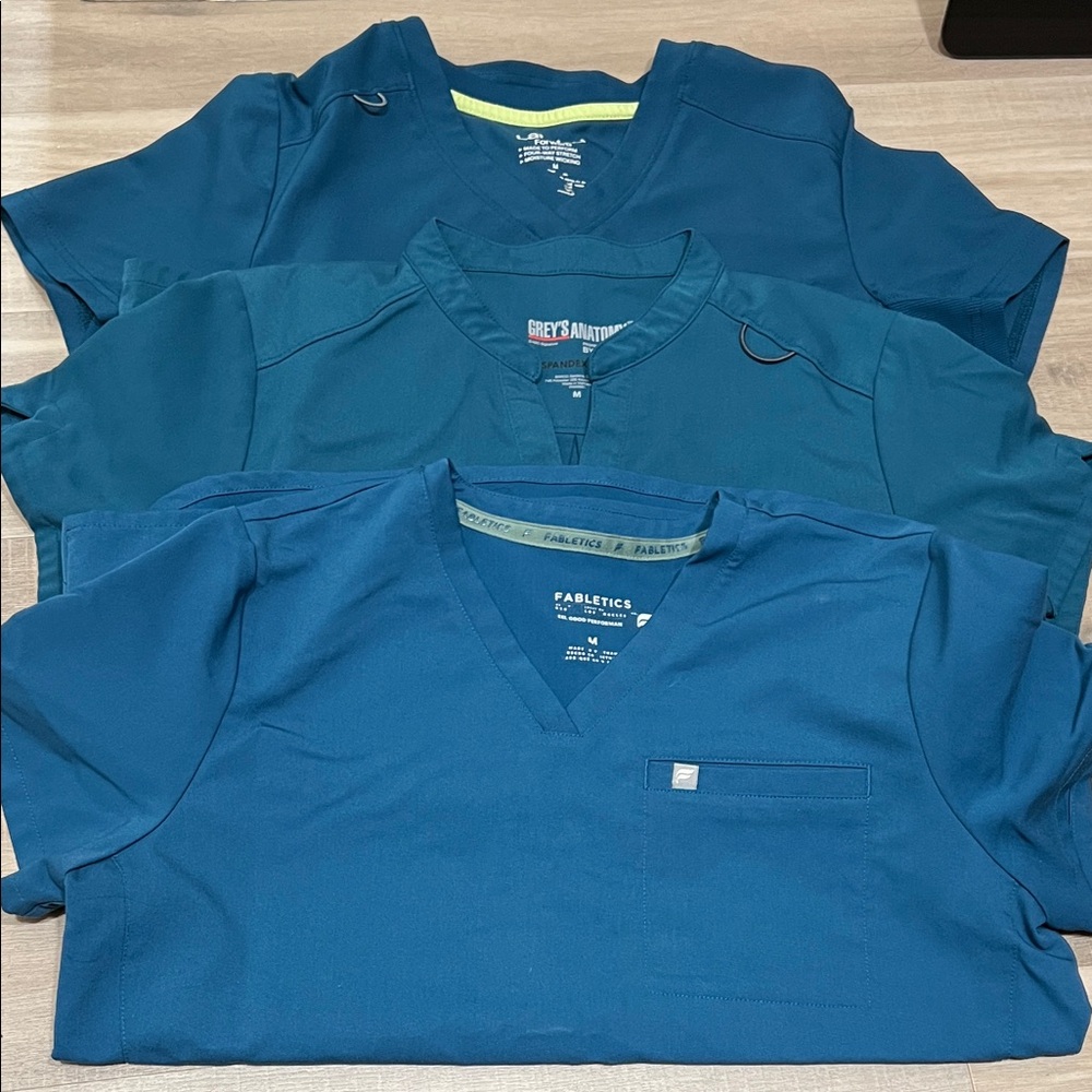 Three scrub tops